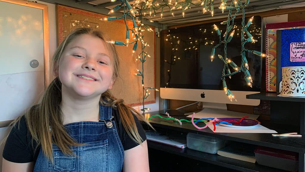 Lainee at her home desk getting ready for online learning.