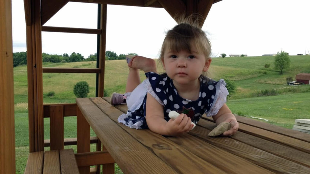 Lainee Hersey outside on porch while Working from Home with Kids